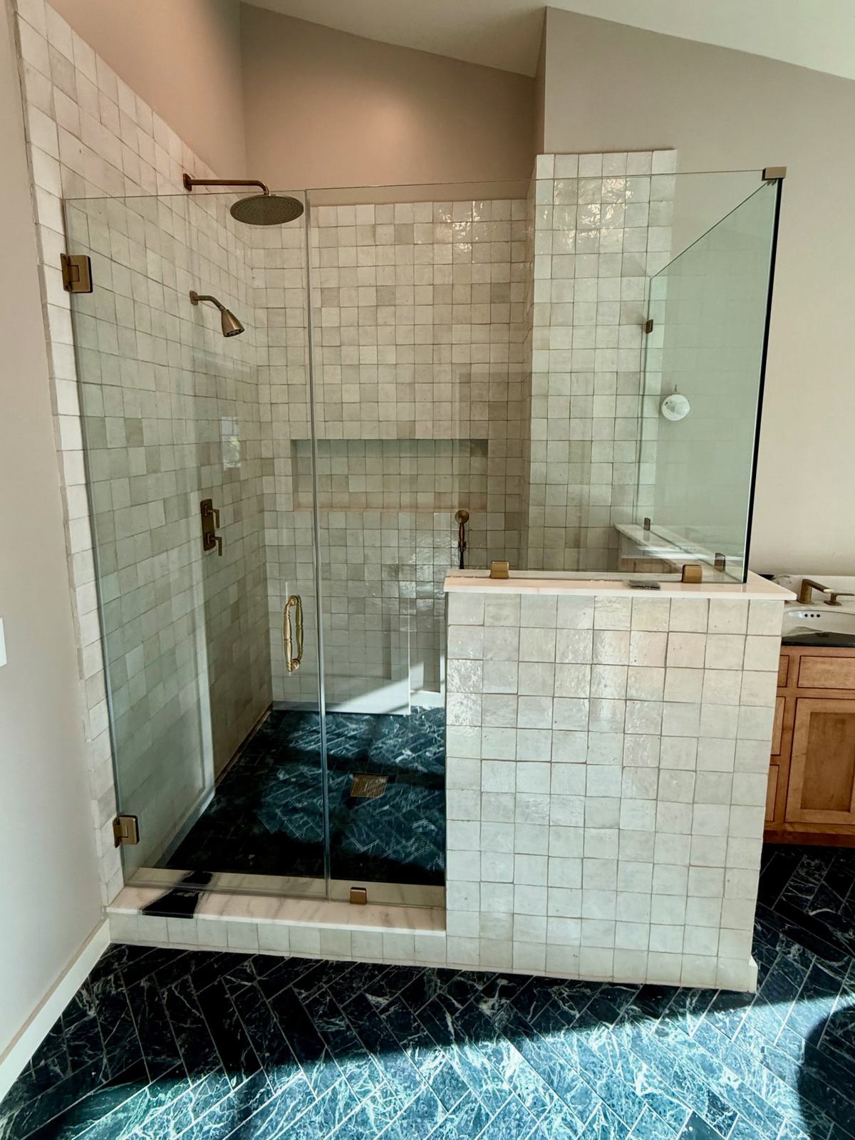 Bathroom with glass-enclosed shower and handcrafted tile
