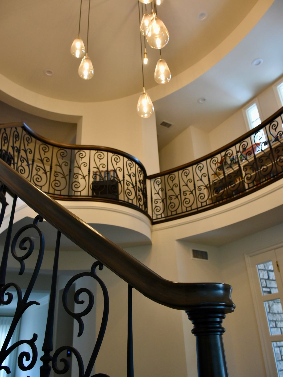 Curved staircase with wrought iron railing